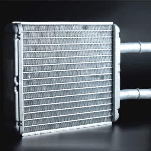 new-interior-heater-radiator-on-a-black-background-aluminum-radiator-spare-parts-fleckney