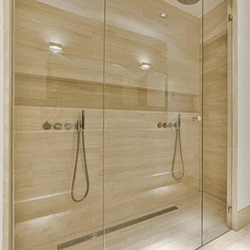 bathroom-with-a-shower-and-a-wooden-door-cosby