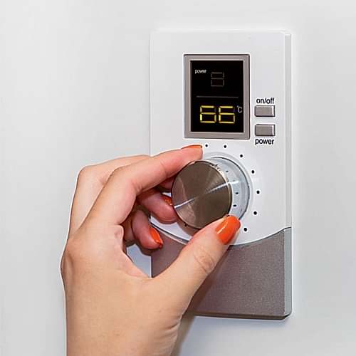 gas-boiler-a-woman-regulates-the-temperature-with-a-temperature-controller-setting-the-room-temperature-cosby